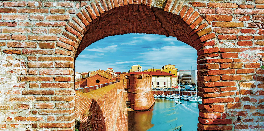 A view through an archway to the harbour of Livorno, Italy